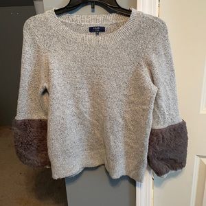 Boutique sweater with textured sleeve pieces